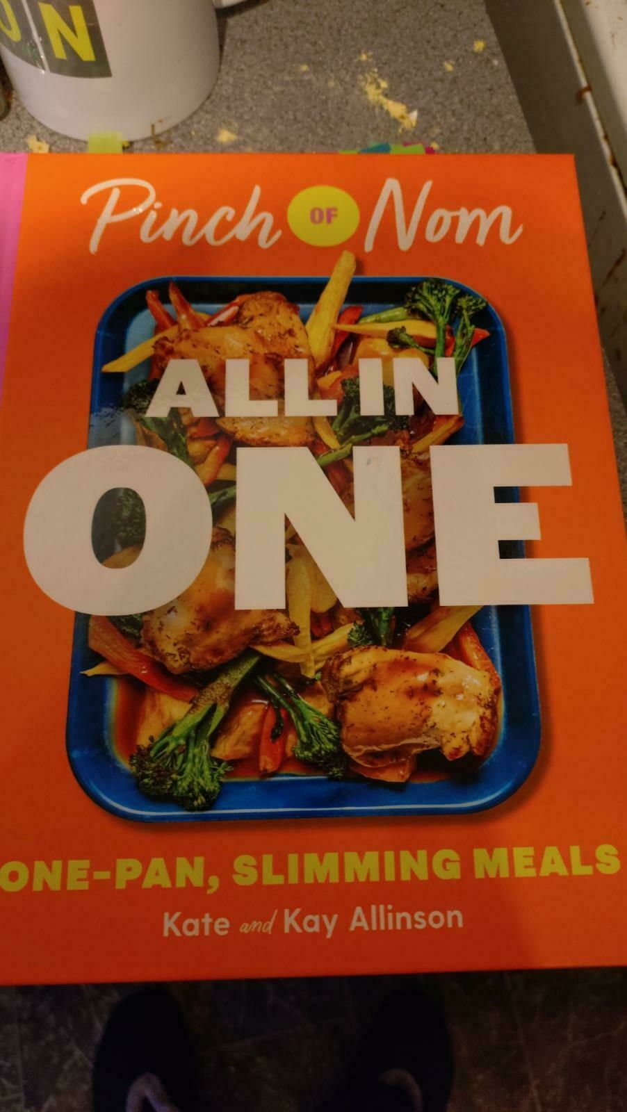 The Pinch of Nom, All in one book cover, coloured tabs marking pages can be seen sticking out the top edge