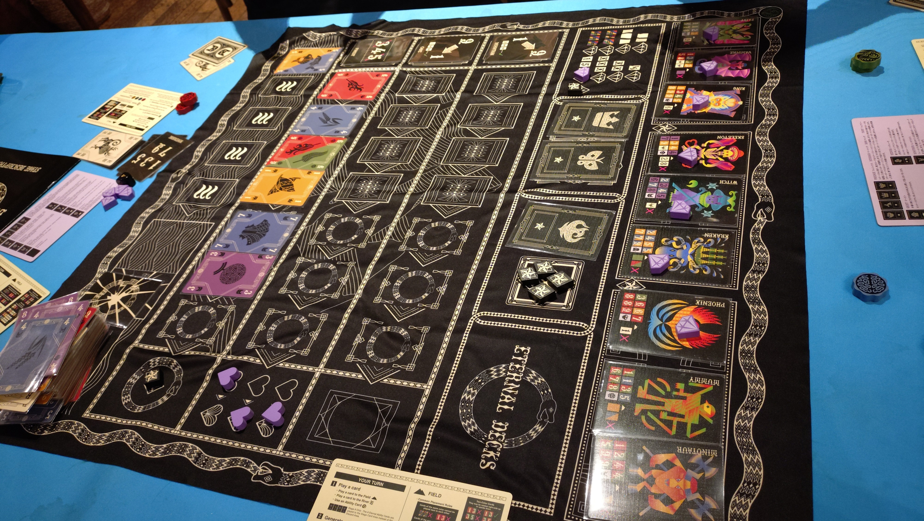 The External Decks end game: A black cloth with many card shaped spaces, 4 stars indicating we won,. and several coloured cards