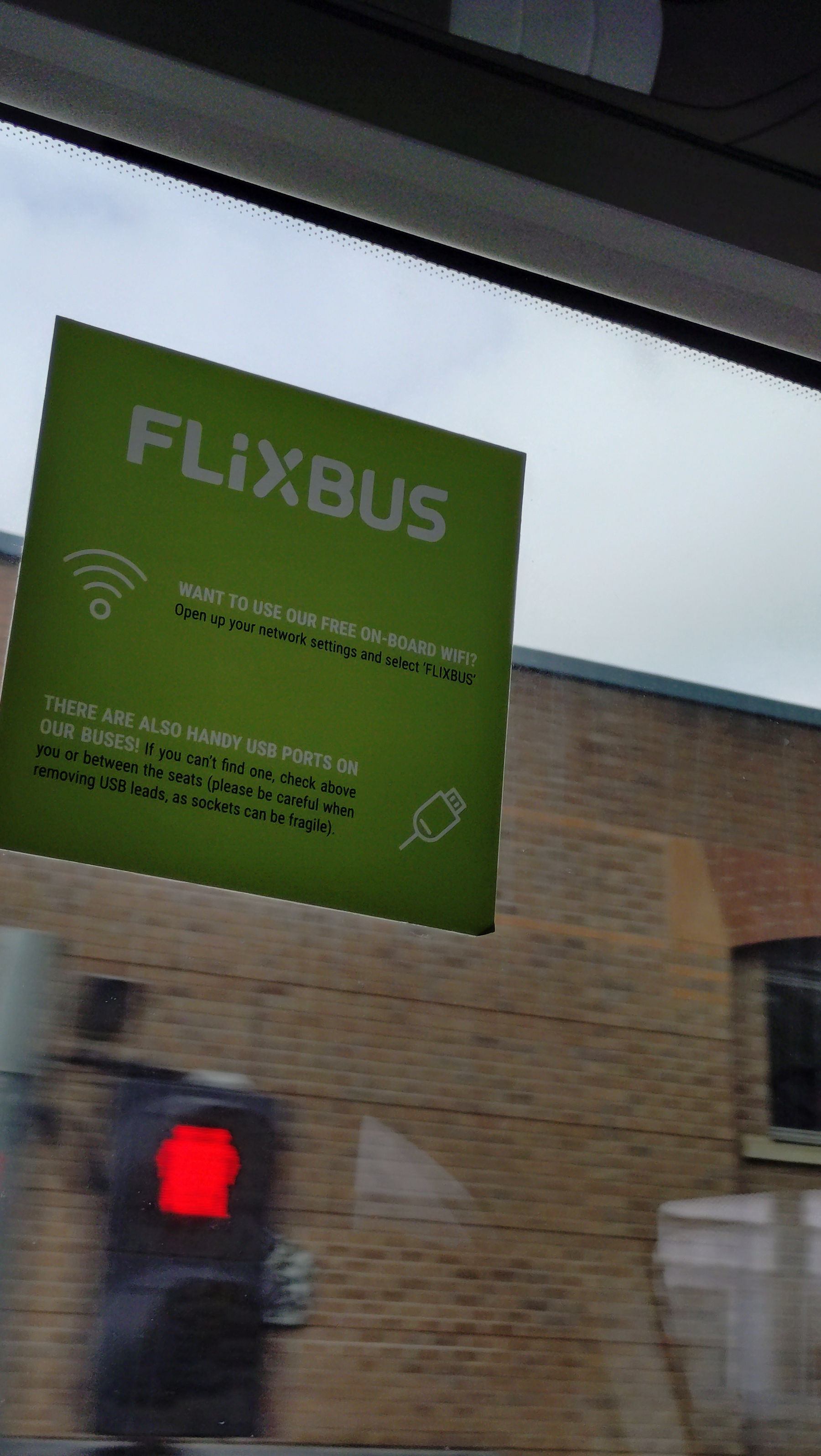 Flixbus window sign showing wifi and charging information &10;